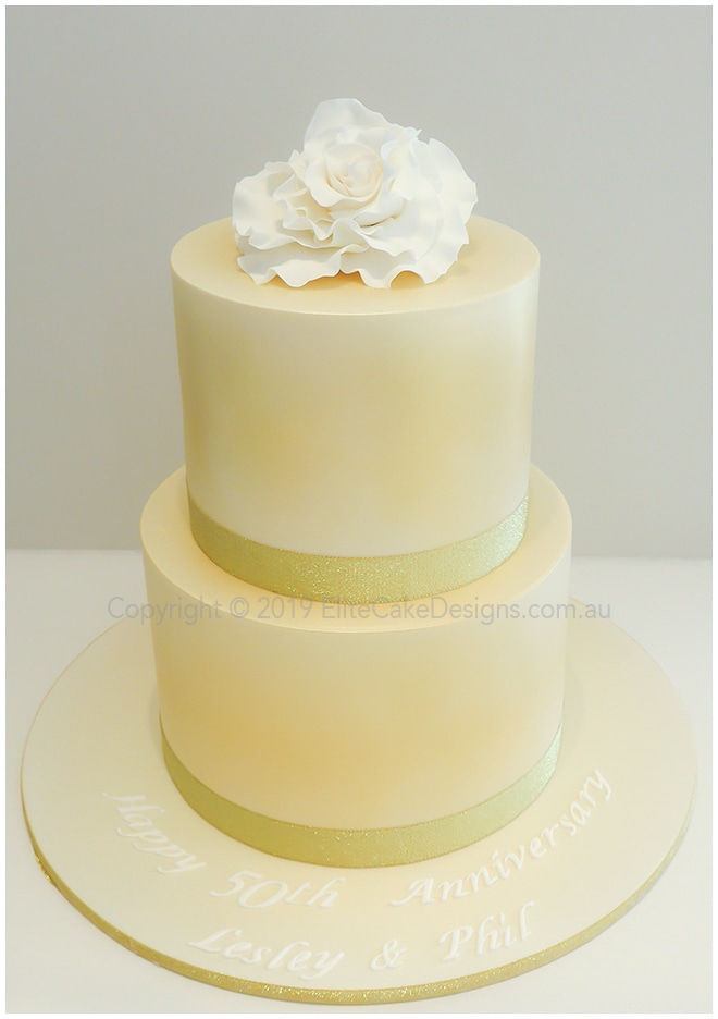 Wedding cake with gold shimmer and white rose